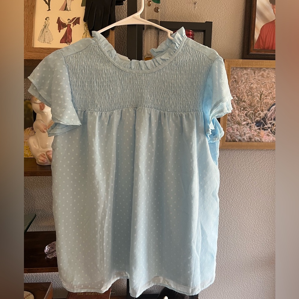 Never worn/ no tags.  Baby Blue size M top bought from Amazon.